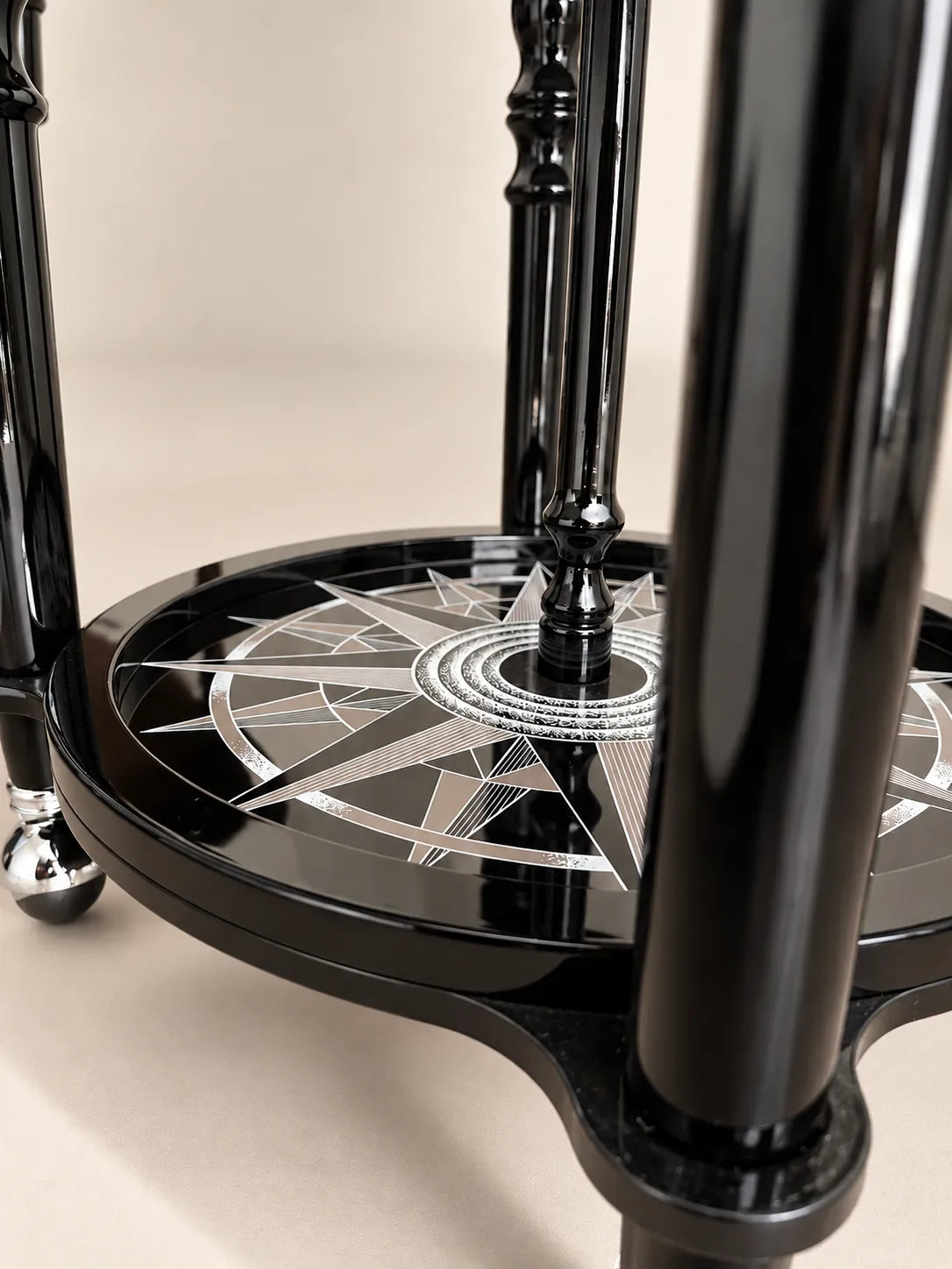 Zoffoli Elegance: detail of the Noir globe bar's glossy legs, compass rose shelf and wheel.