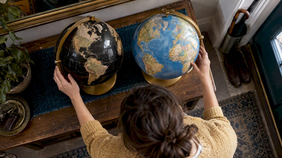 Black and blue ocean globes side by side