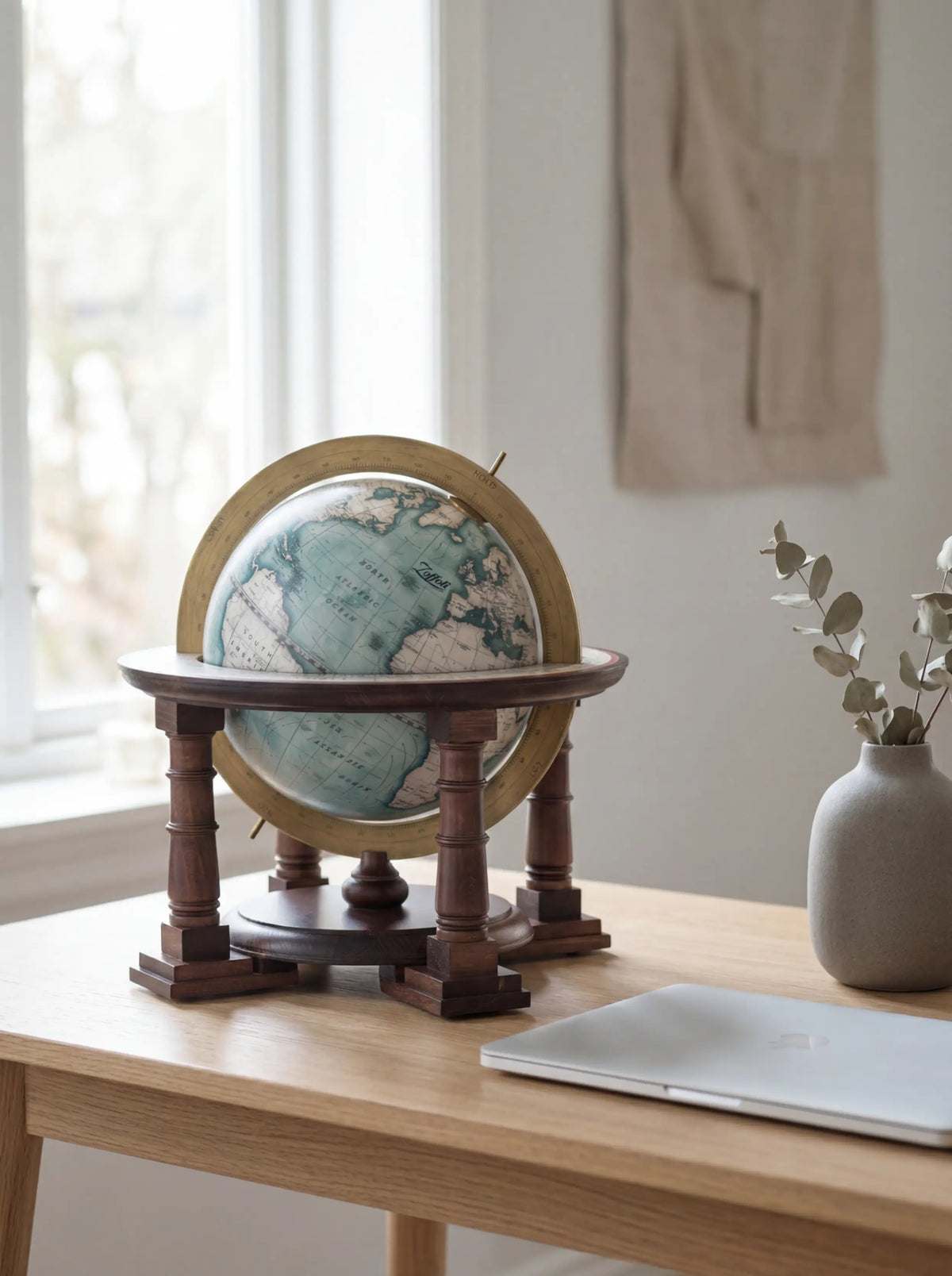 Zoffoli Cassini: blue tabletop globe on a windowsill beside a white vase.