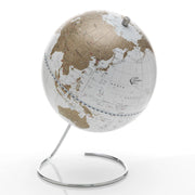 Zoffoli Cosmo: White tabletop globe with gold-toned continents and an open circular metal stand.