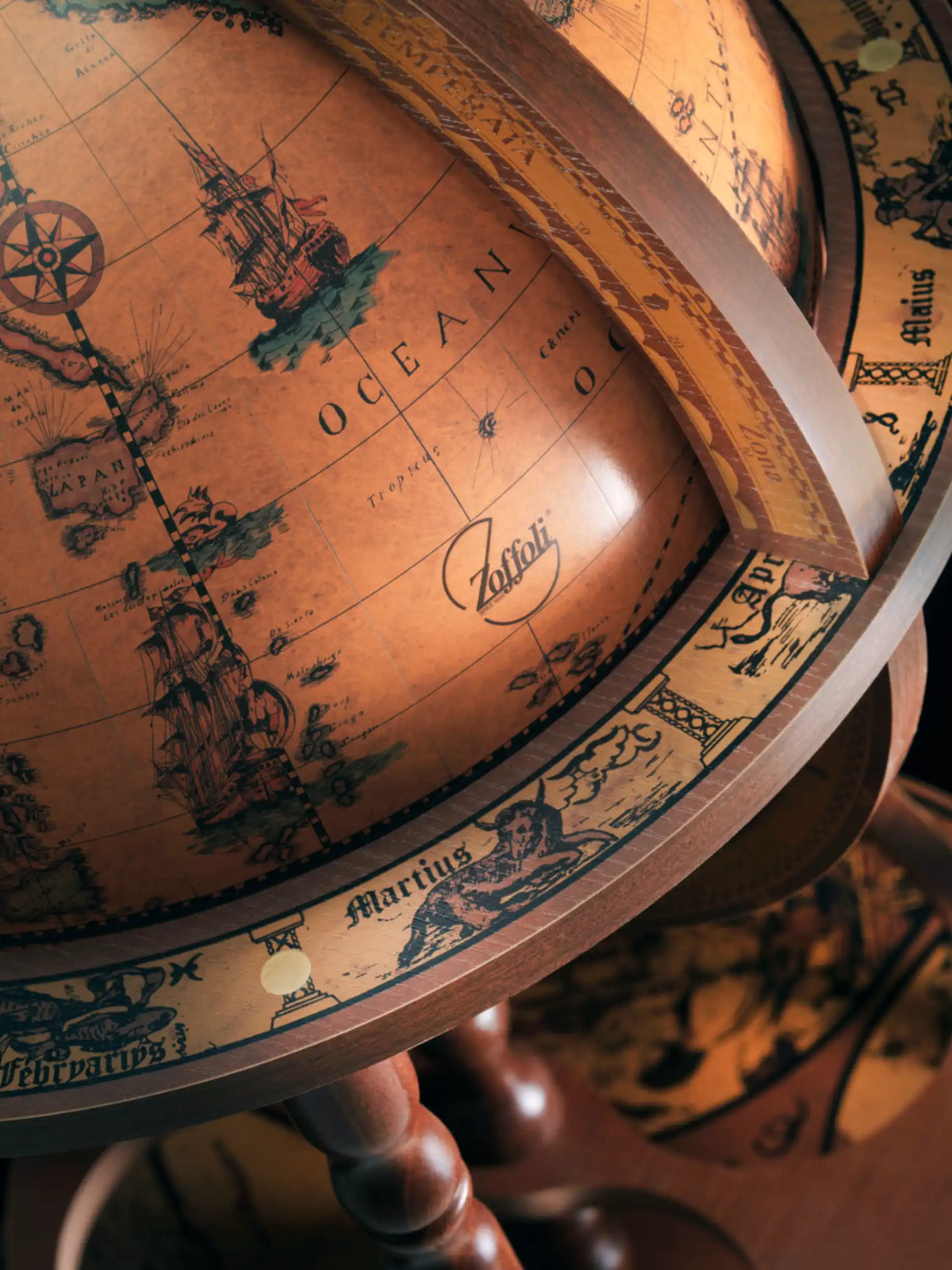 Close-up of the Giunone globe bar's brown world map and numbered ring.