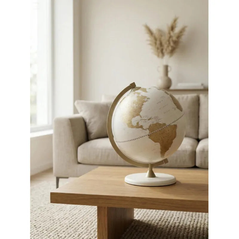 Zoffoli James Cook: White Gold globe on a coffee table in a bright living room.