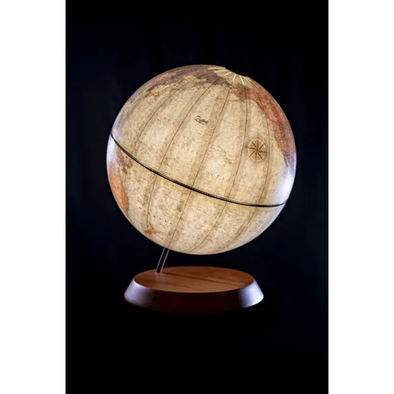 Zoffoli LUME: illuminated globe lamp with a pale map and wooden base against a dark background.