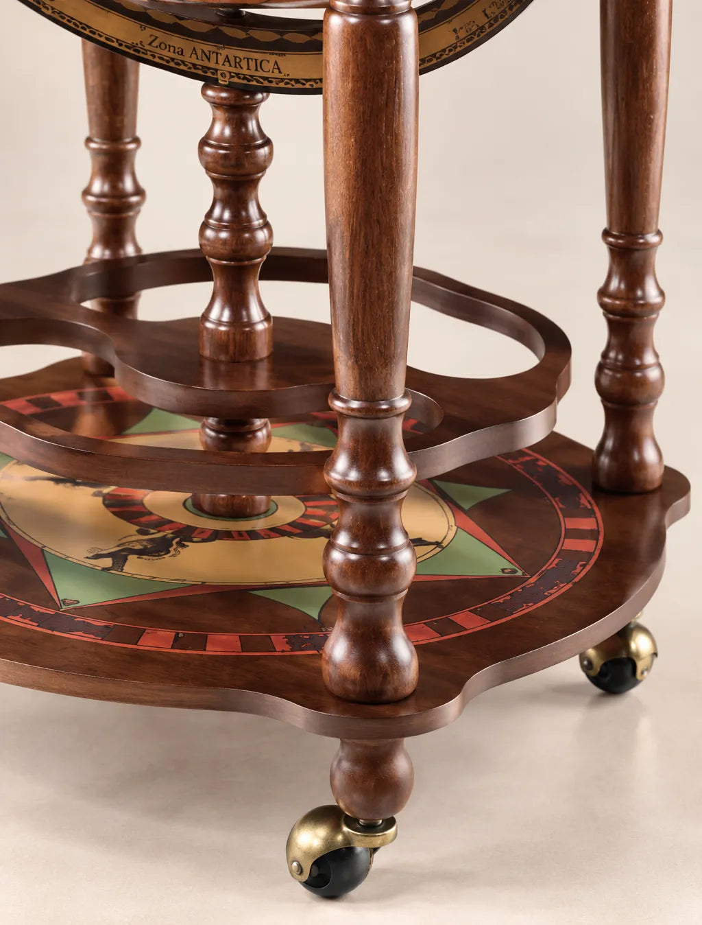 Zoffoli Minosse: detail of the turned wooden legs, lower compass rose shelf and wheels.