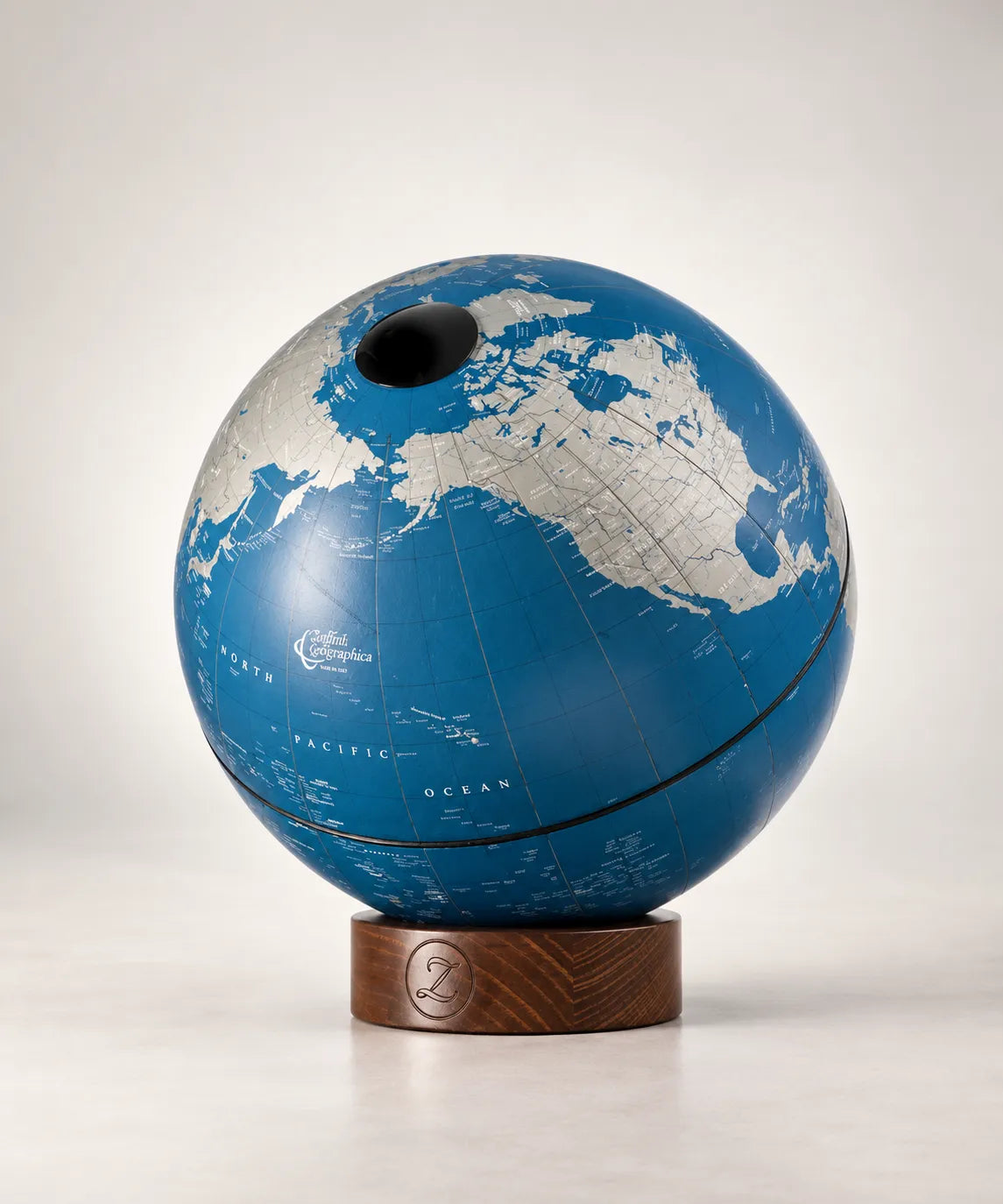 Zoffoli Orbis: Tortora decorative globe showing a blue map and small wooden base.