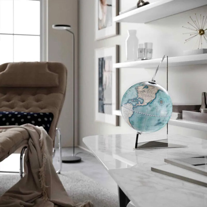 Zoffoli Vela: Indigo globe on a marble coffee table in a bright living room.