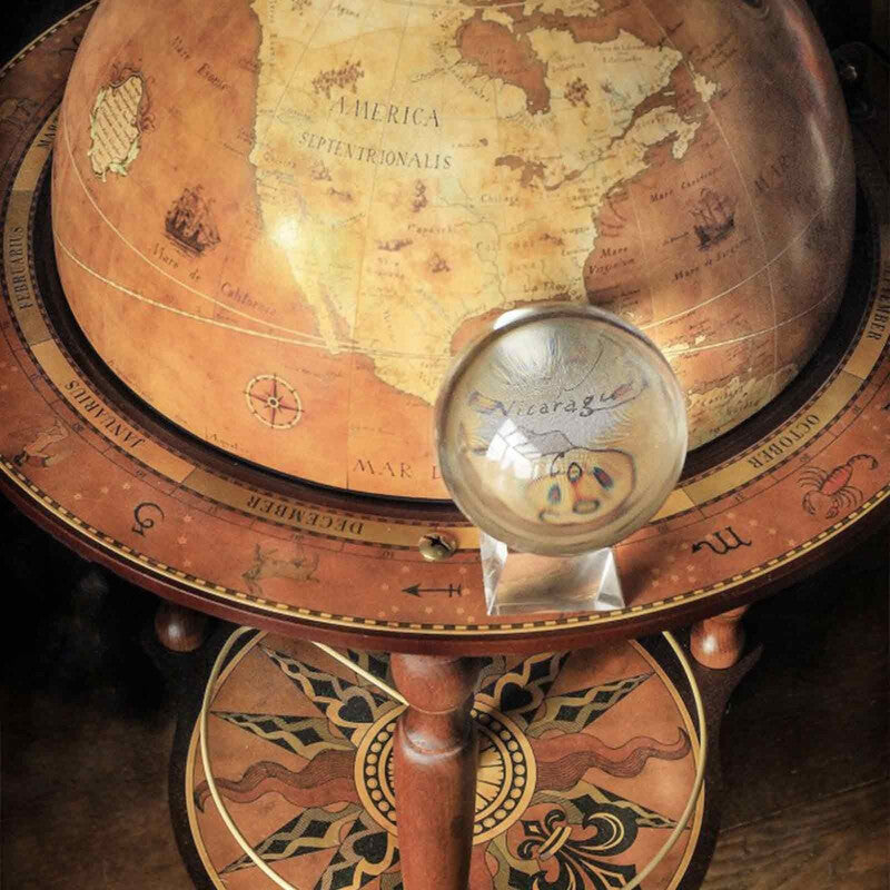 Close-up of the Da Vinci Rust globe bar with its antique-style map, lower compass rose and a smaller globe.