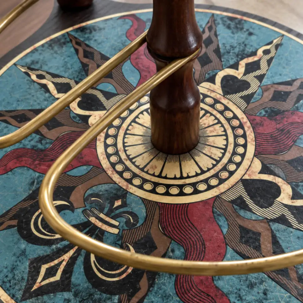 Detail of the Da Vinci Blue Dust globe bar's decorated lower shelf, wooden legs and metal rail.