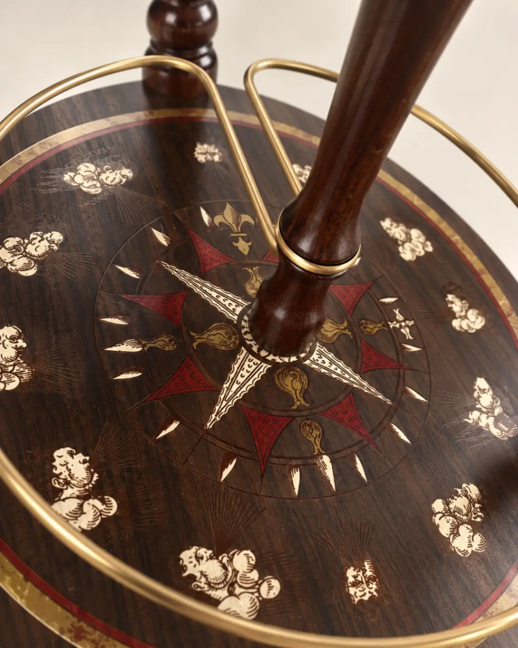Zoffoli Explora: detail of the decorated compass rose shelf, wooden legs and metal rail.