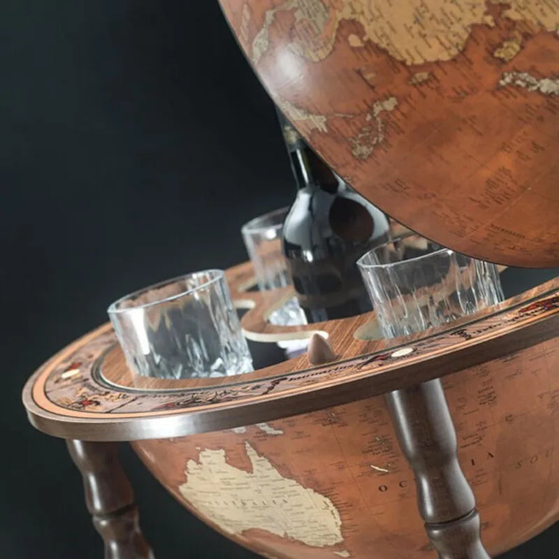 Zoffoli Petra: detail of glasses and a bottle arranged inside the open globe bar.